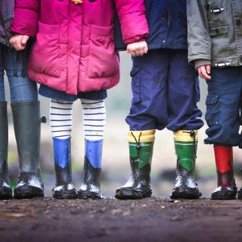 kids standing with rain boots on